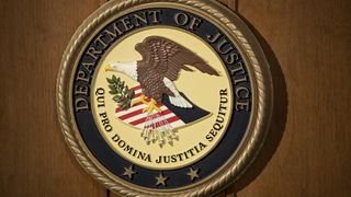 The Department of Justice seal on a podium during a news conference at the U.S. Attorney's Office in New York, U.S.