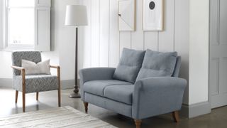 small grey sofa in living room with painted panelling