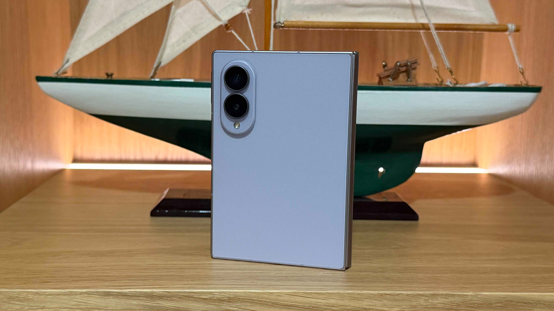 Samsung Galaxy Z Fold 8 smartphone leaning up against model yacht, showing back of unit and rear camera array