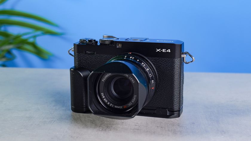 Fujifilm X-E4 on a stone surface and blue background