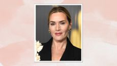 Image of Kate Winslet smiling with her blonde hair in an updo and wearing a black blazer with white flowers, on a pink watercolour background