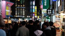 A bustling street at night in Seoul, South Korea.