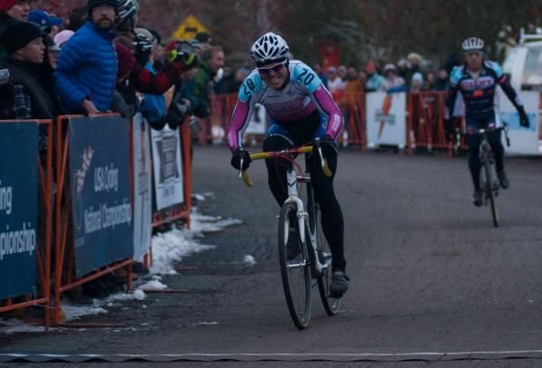 A Bold smiling Johnny crosses the finish to win the Championship jersey for the 44-49 Men's Race.