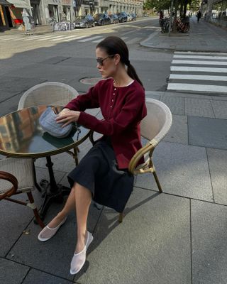 Girl wearing a burgundy sweater and white mesh shoes