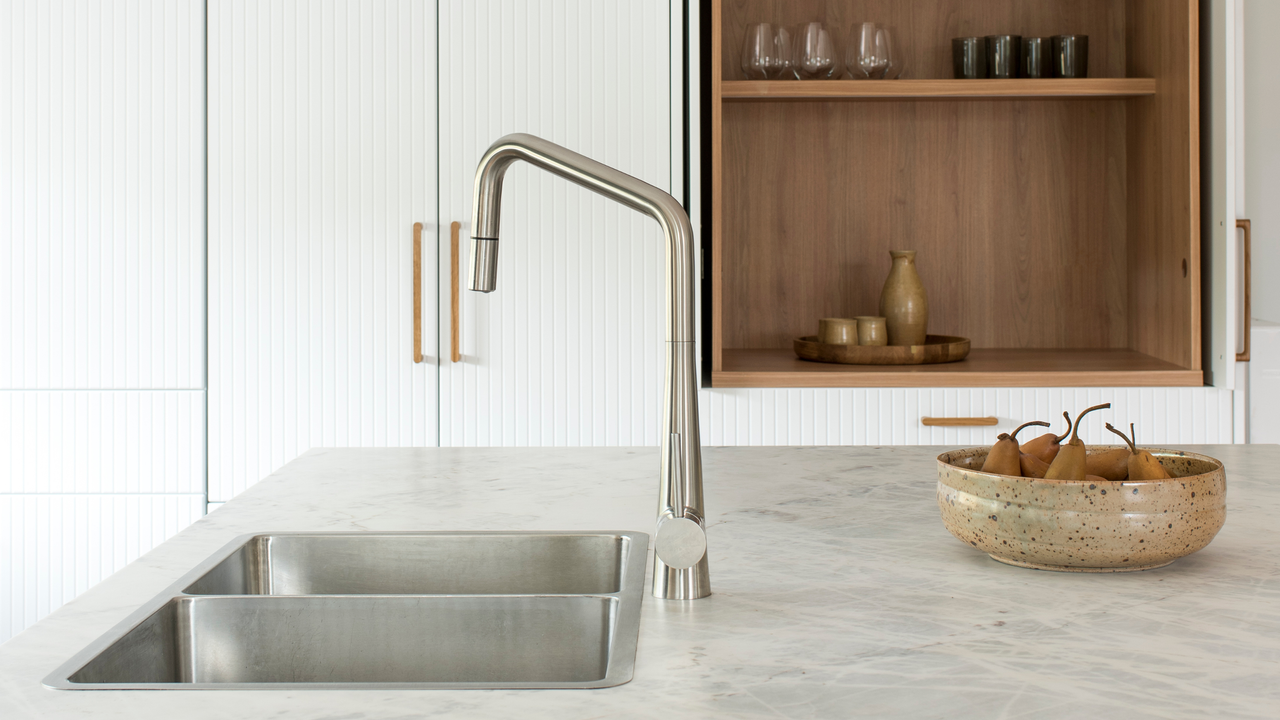 A stainless steel sink in a chic kitchen 