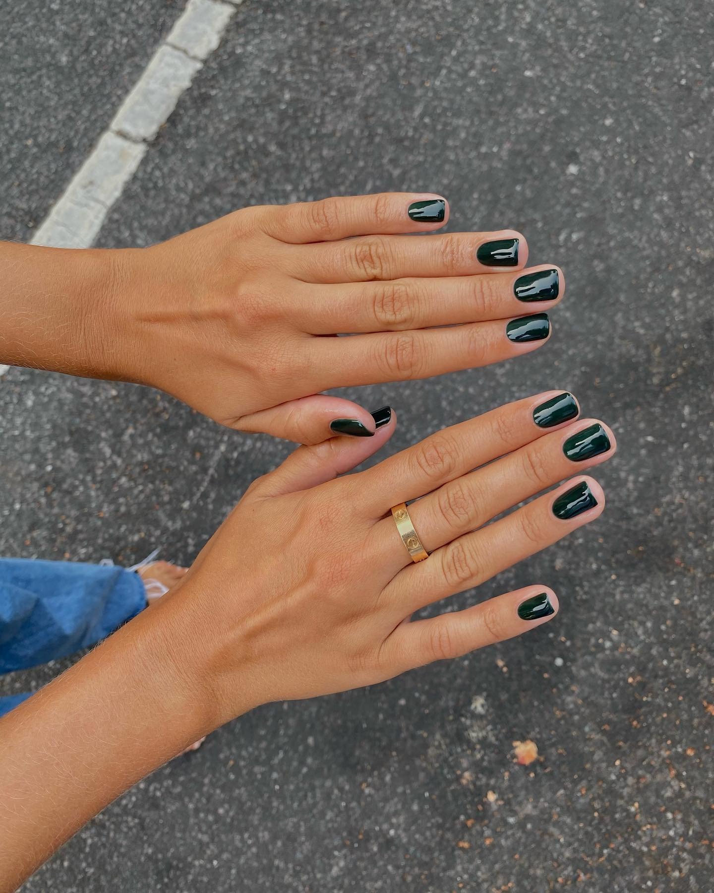 Person wearing dark green jelly nail polish.