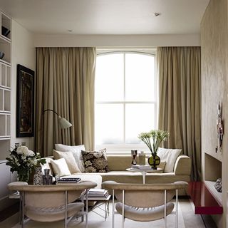 living room with white walls and curtains on window