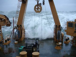 Frigid waves crash onto the deck of the Healy as the ship navigates rough Arctic seas.