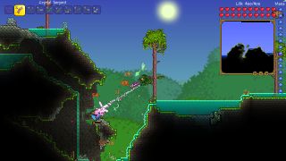 Hanging from a tree in Terraria and attacking an enemy that lurks just below