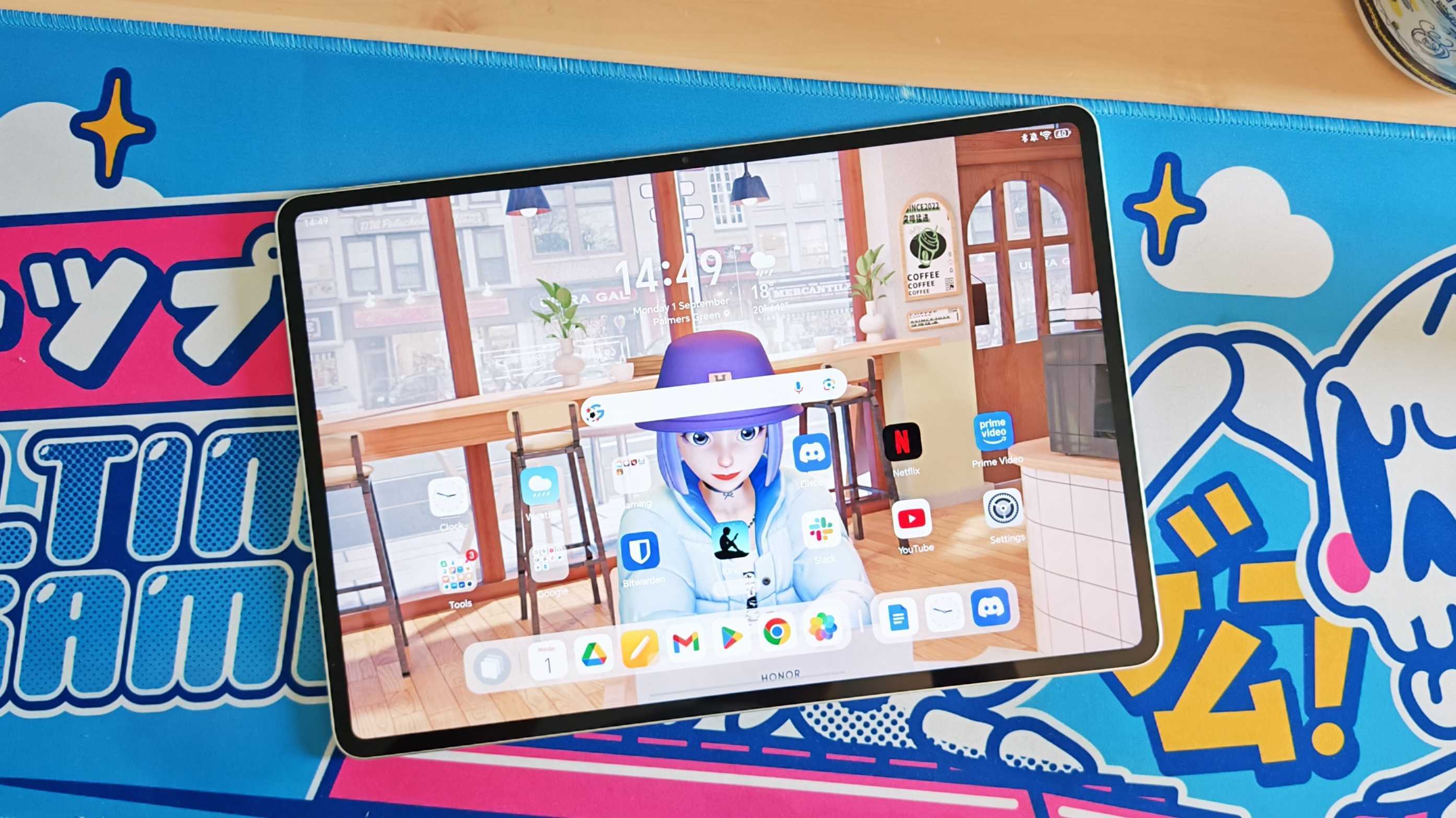 The Honor MagicPad 3 placed on a colorful desk mat.