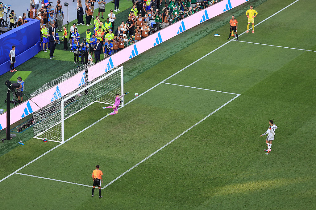 Paraguay goalkeeper Orlando Gill saves Kai Havertz's penalty for Germany