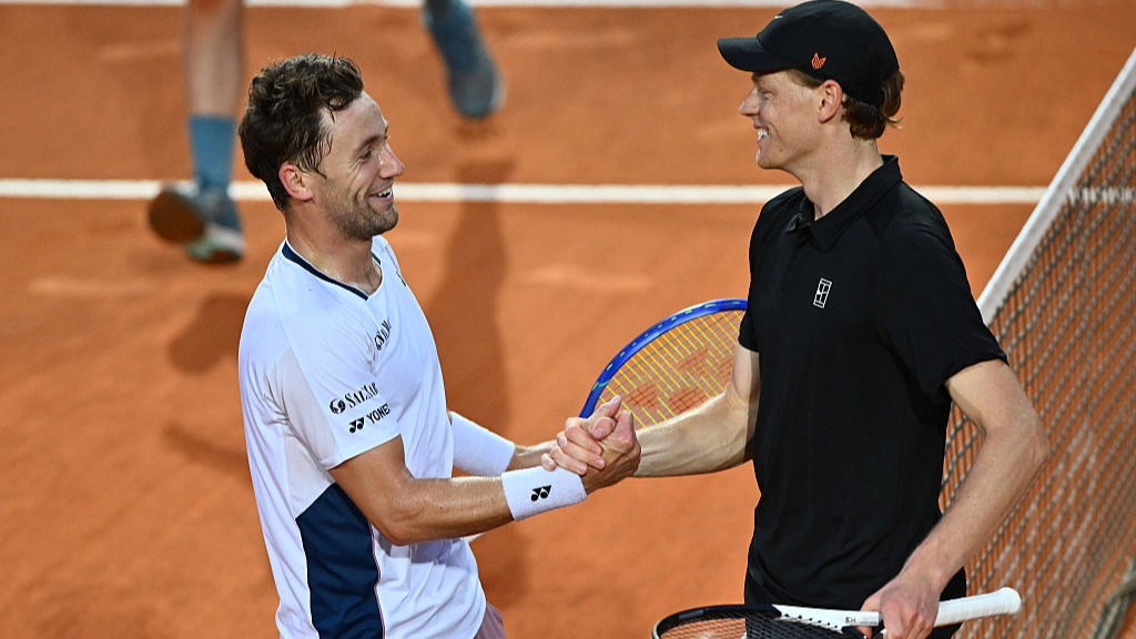 Casper Ruud and Jannik Sinner shake hands at the net after a match at the Italian Open 2025