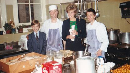 Princess Diana posing with Prince William and two men wearing aprons in a kitchen at homeless charity The Passage