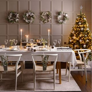 dinning room with christmas decoration grey panel wall and christmas tree