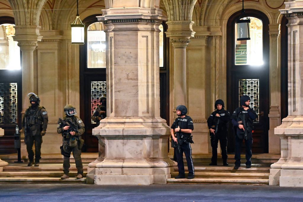 Police stand guard following shooting in Vienna.