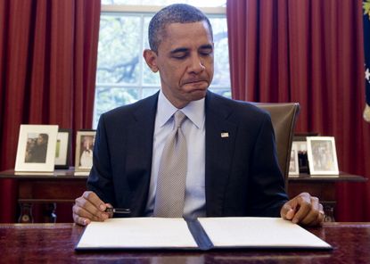 Barack Obama reads a presidential brief.