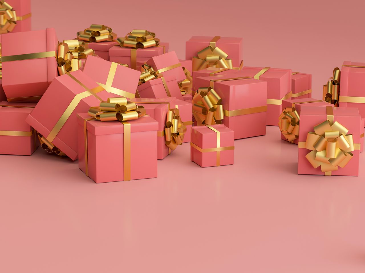 A stack of gifts in pink wrapping paper with gold bows