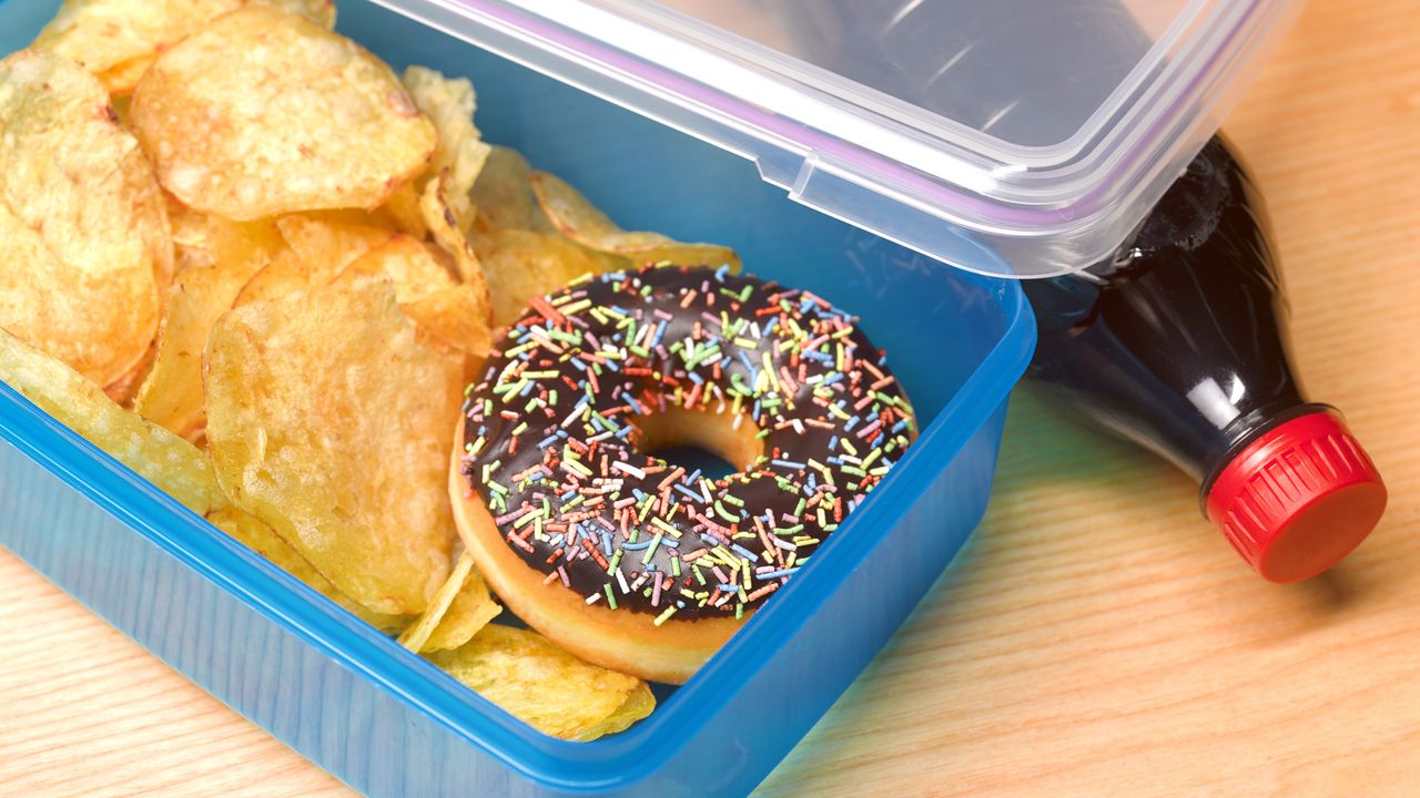 Lunch box filled with chips and a doughnut