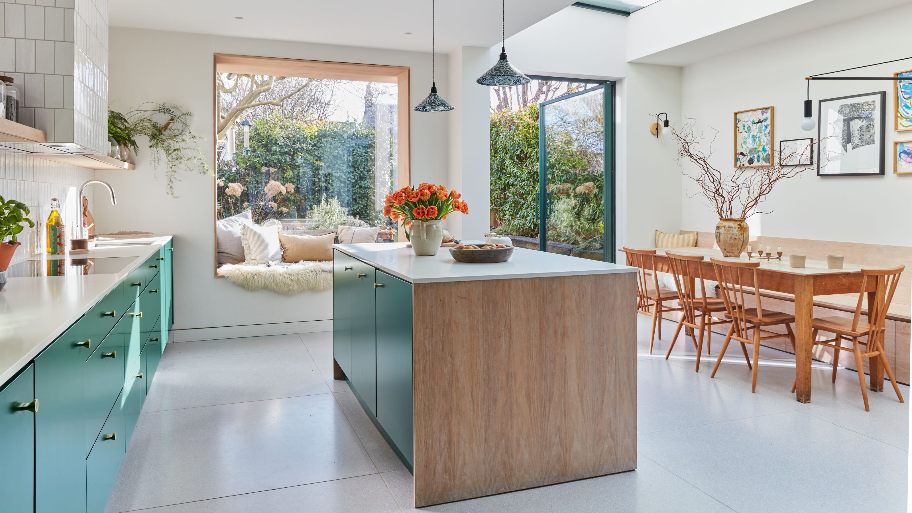 Large open-plan kitchen-diner with blue cabinets and a matching kitchen island