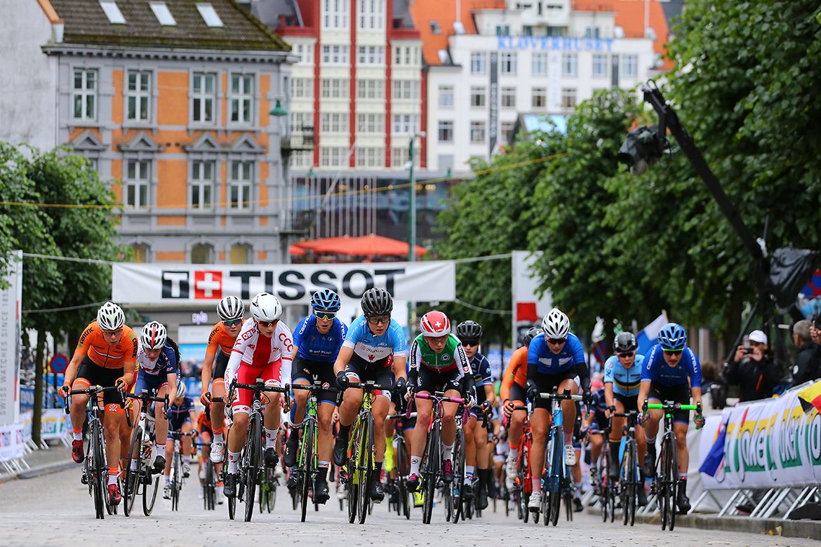 The peloton crosses the cobbles