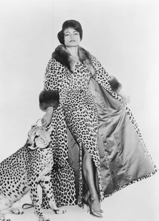 Eartha Kitt wearing matching leopard print coat and gown