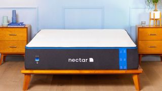 The Nectar Memory Foam Mattress, shown on a light wooden bed frame, is one of the best-selling mattresses in a box