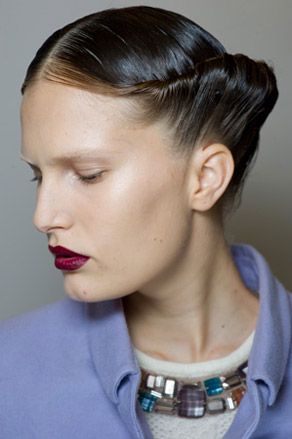 Model's twisted hairstyle and dark lips