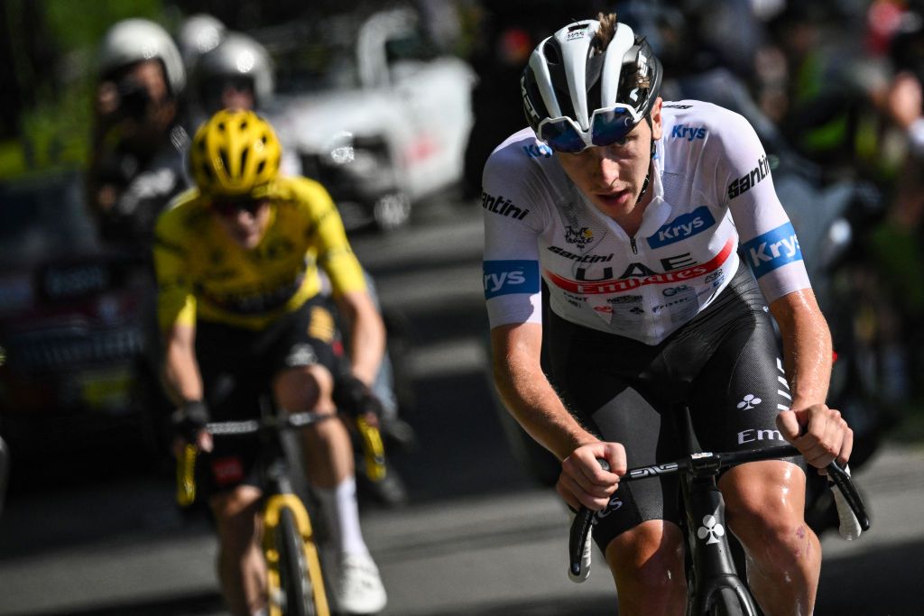 UAE Team Emirates' Slovenian rider Tadej Pogacar wearing the best young rider's white jersey attacks, cycling ahead of Jumbo-Visma's Danish rider Jonas Vingegaard wearing the overall leader's yellow jersey in the final ascent on the Col de Joux Plane during the 110th edition of the Tour de France cycling race, 152 km between Annemasse and Morzine Les Portes du Soleil, in the French Alps, on July 15, 2023. (Photo by Marco BERTORELLO / AFP)