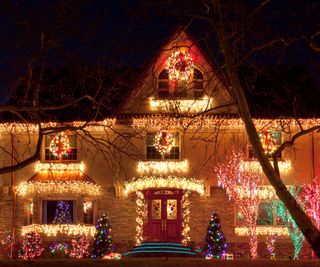 Multicolored Christmas lights decorating the front of a home