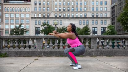 Woman holding a squat