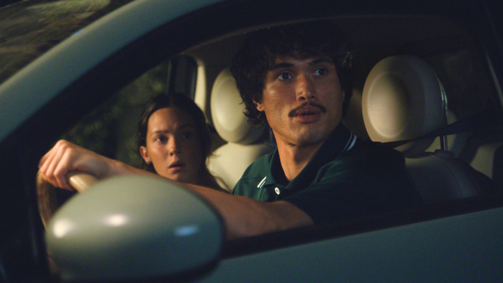 Ashley and Austin look at something out the driver's window