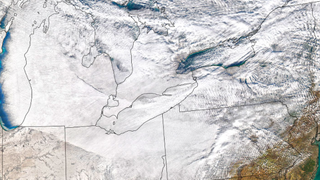 satellite photo of the northeastern united states and ontario overlaid over a map. snow is in most of the image