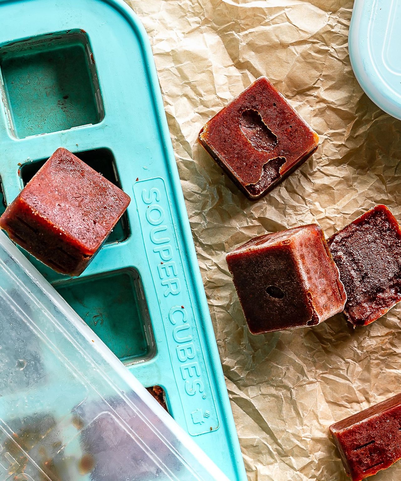 Souper Cubes of small frozen fruit puree or dark tomato based sauce