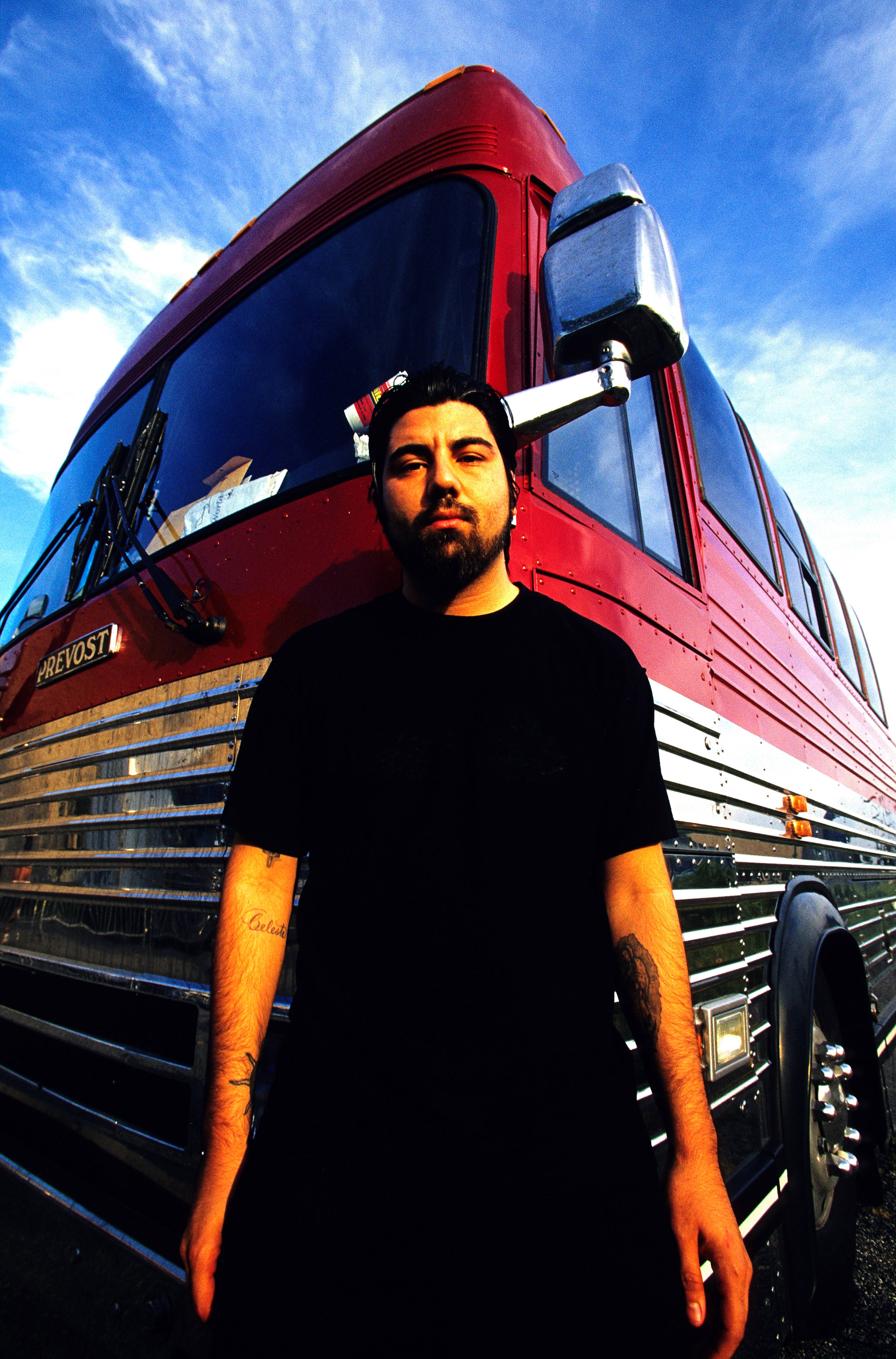Chino Moreno in front of a tour bus in 2000
