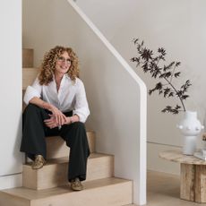 Kelly Hoppen sitting on stairs