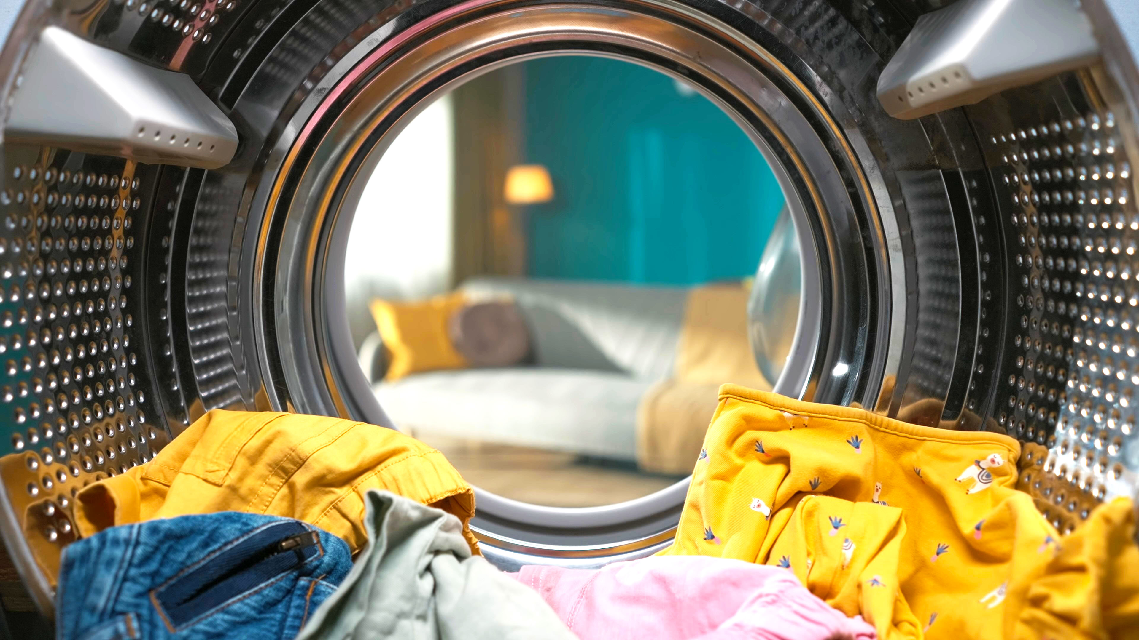 Inside a washing machine with yellow clothes inside.