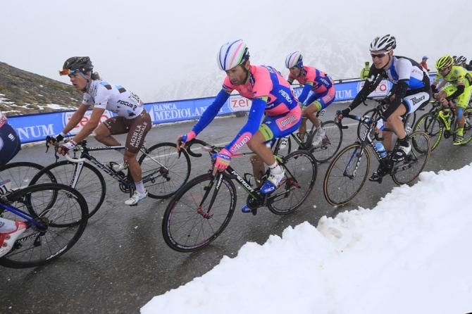 Michele Scarponi (Lampre) rides alongside Bentancur as the snow begins to fall