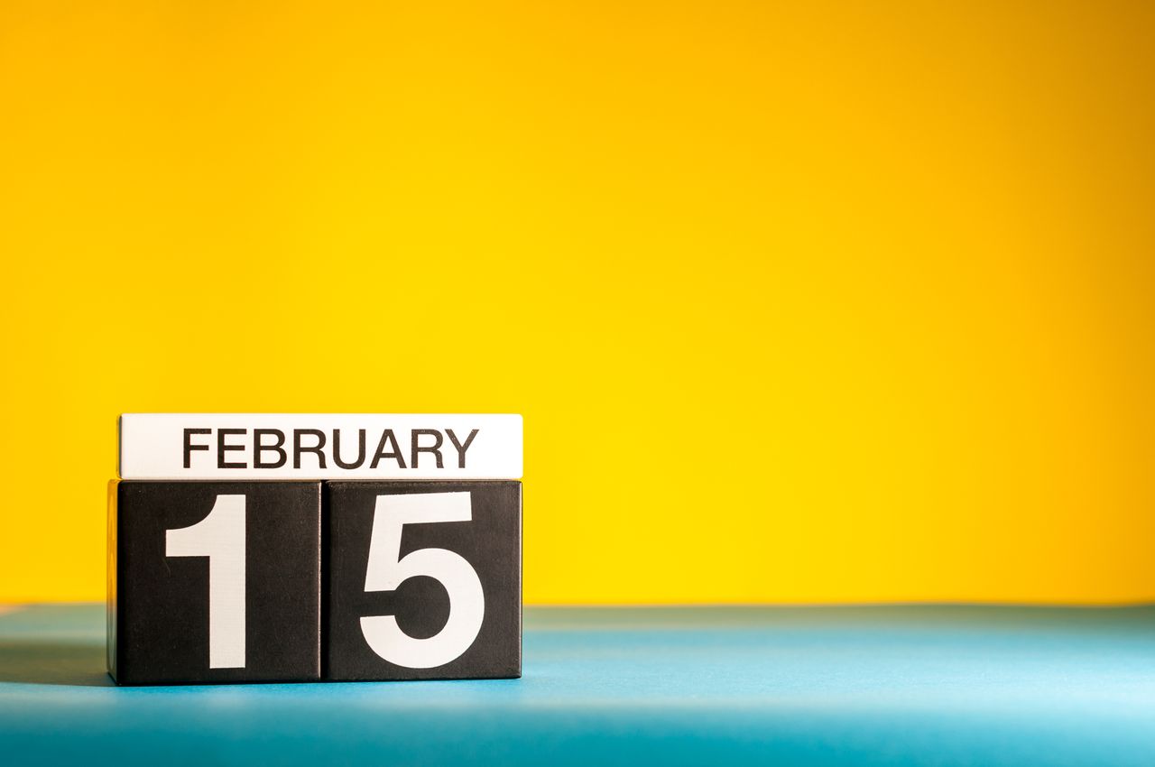 February 15 blocks on a blue surface against a yellow background