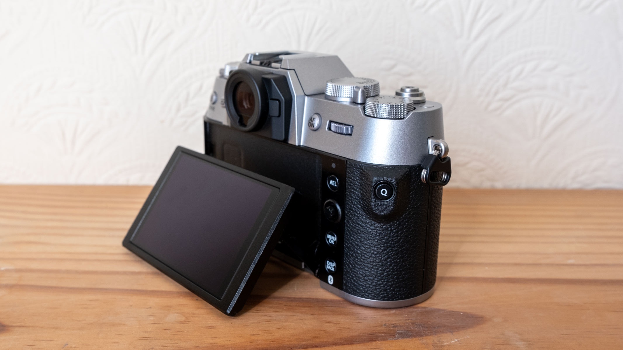 The Fujifilm X-T50 with its tilting screen on a wooden shelf