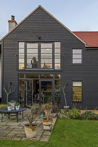 exterior of contemporary black clad home in winter