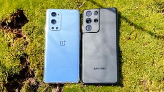 OnePlus 9 Pro and Samsung Galaxy S21 Ultra face down on mossy ground