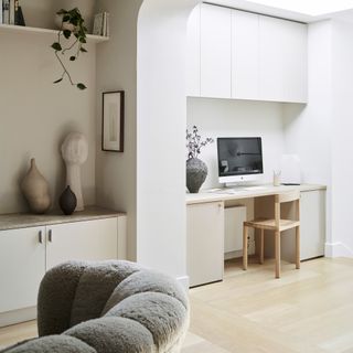 neutral open plan home with a work desk and computer