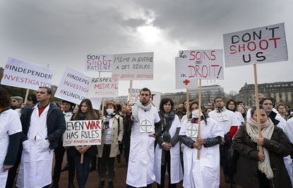 Doctors Without Borders members protest the bombing of a hospital in Kunduz at a protest in Geneva.