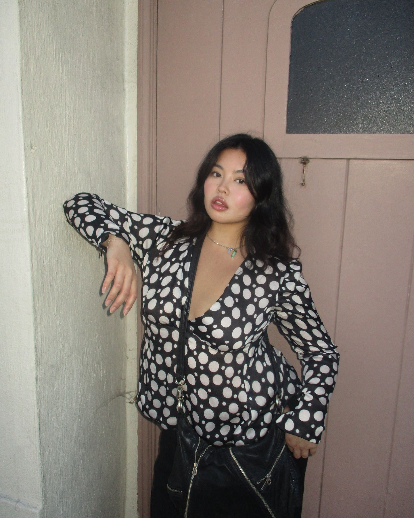 Influencer wears a polkadot blouse