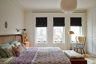 White bedroom with cane headboard