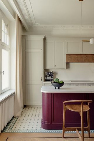 A kitchen with patterned floor tiles