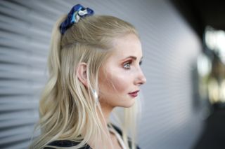 Half ponytail hairstyle with a sustainable scrunchie made out of old Hermes scarfs by James as a detail of german model Anna Hiltrop during a street style shooting at Centro on September 7, 2020 in Oberhausen, Germany.