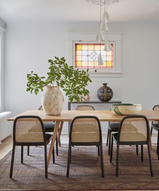 Dining room with cane dining chairs by Sam Sacks Interior Design, photograph Lauren Miller