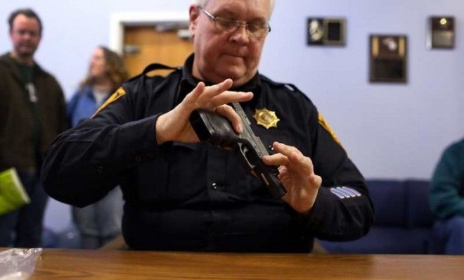 Lt. Ray Mesek registers a pistol at a gun buyback event at the Bridgeport Police Department in Connecticut on Dec. 22.