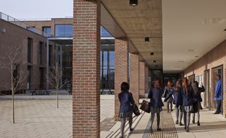 Students in uniform walking in external corridors of Drapers Academy